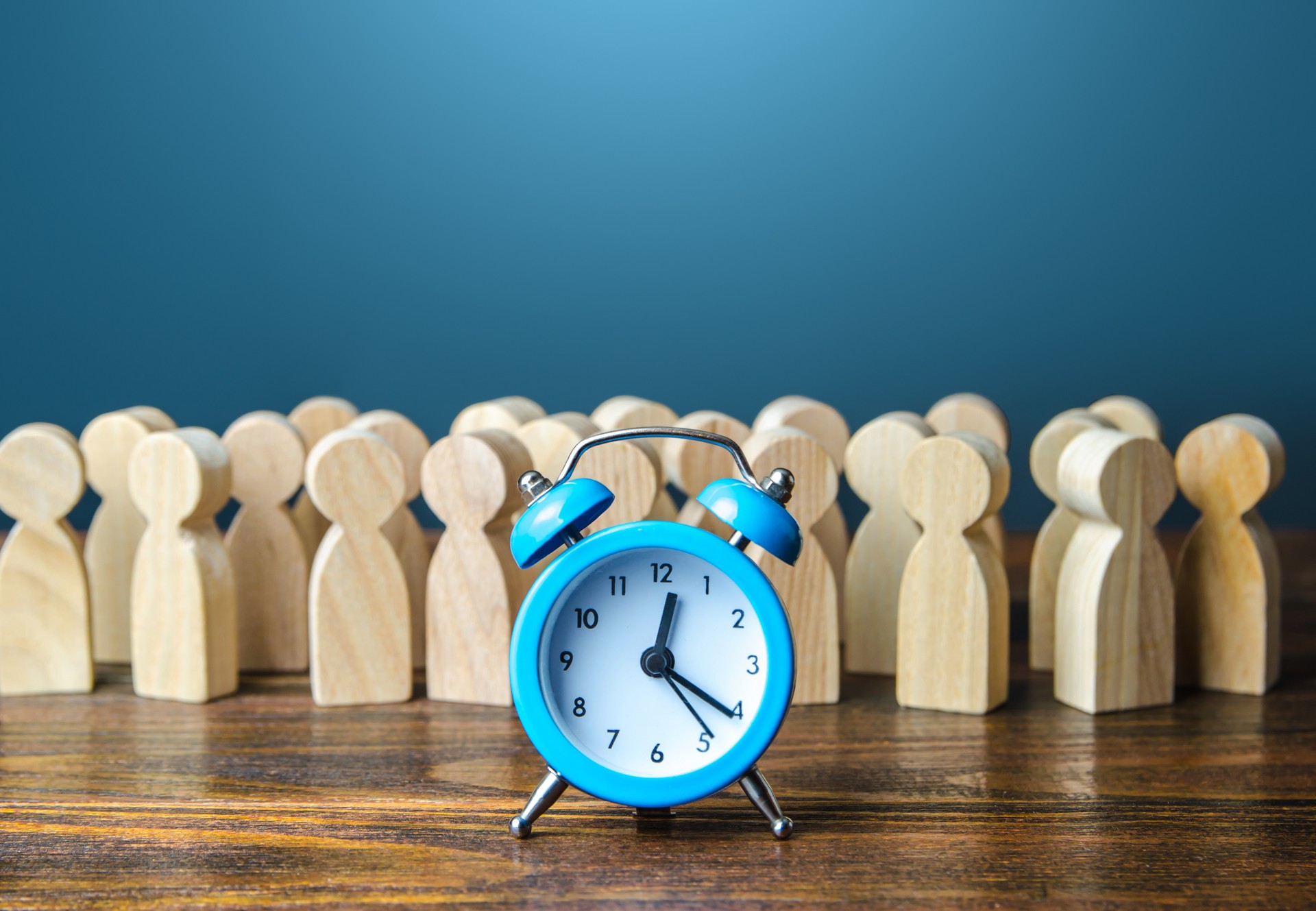 Alarm clock and a crowd of people. Time management. Hourly wages, strict work limits and break time. Planning and forecasting. Employee performance monitoring system, Organization of business